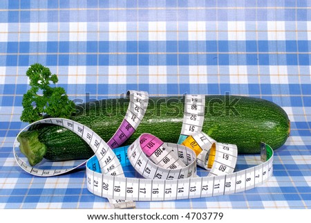 fresh vegetables, zucchini, courgette, being on a diet, measure tape around,  Food, healthy eating concept.