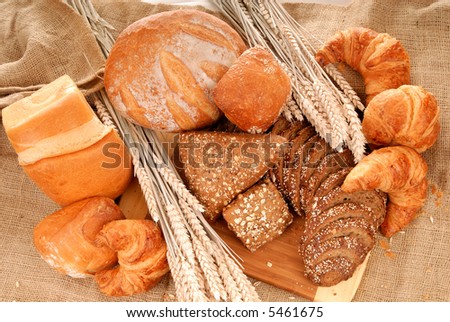 Variety of nutritional breads, ranging from simple white to whole wheat, freshly home baked on burlap, jute cloth