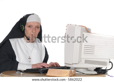 Middle aged nun, sister on computer, connection with god.  Religion, christianity, lifestyle,  communication concept