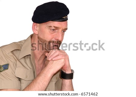 Attractive, mid fifties bearded praying soldier in uniform, hands crossed under chin