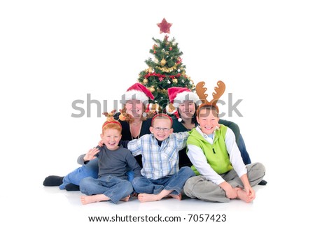 happy youngsters, teenage girls and boys around Xmas, Christmas three with presents, gifts.  White background.