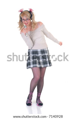 Attractive teenage singer star, performing song, microphone in hand, headphones on head.  White background.