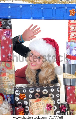 Smiling attractive teenager girl teen surrounded with Christmas xmas gifts.  White background.