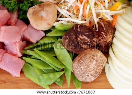 Wok cooking, cutting board with vegetables and meat,  studio shot