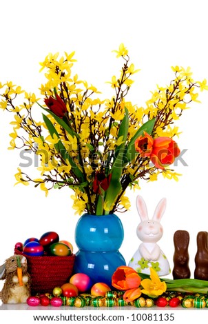 Variety of chocolate eggs and Easter flowers. Studio shot, reflective surface, copy space