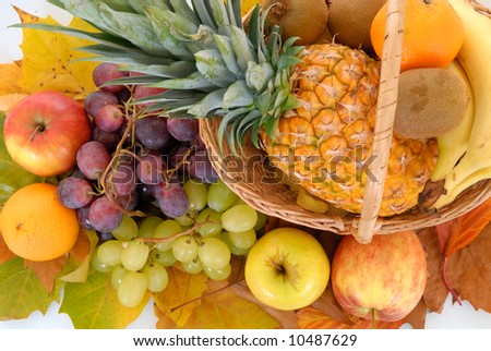 Fresh seasonal fruit, pineapple, apples, bananas, kiwi, grapes, mandarin, orange and glass fruit juice