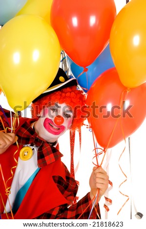 Colorful dressed male holiday clown with balloons, happy joyful expression on face. Studio shot.