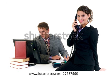 Businessman on computer with assistant making phone call  in the office.  Studio, white background