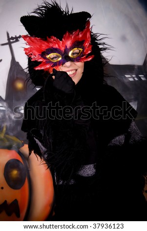 Halloween character, female cat costume.    Studio shot, painted themed background.