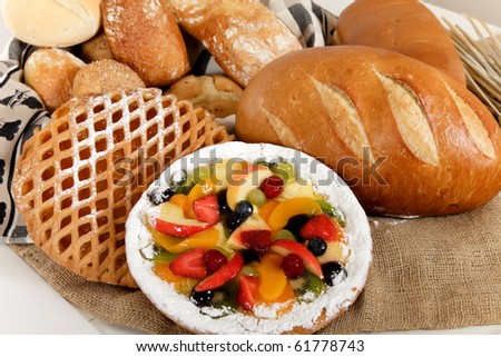 Display of various type of bread and fruits pie. Focus on fruits pie. Studio shot.