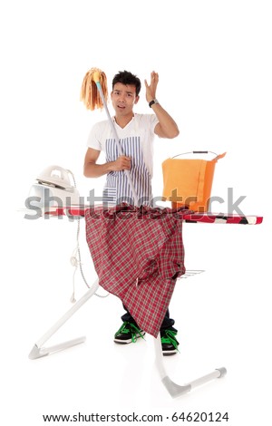 Young handsome Nepalese man stressed, ironing and cleaning. Studio shot, white background.