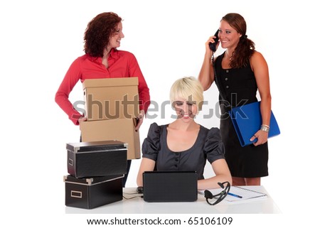 Three successful young businesswomen enjoying their work. Studio shot. White background.