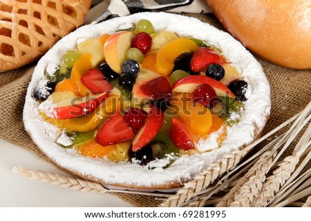 Close up of a tasty sweet colorful tart with fresh fruits and jelly.  Fruits mix. Studio shot.