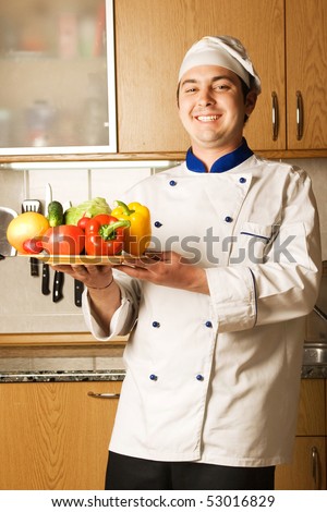 happy chief with colored vegetables