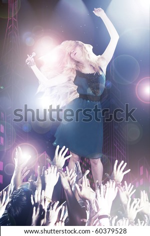young singer on the stage in the bright rays of spotlights