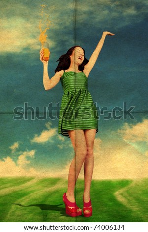 beauty young woman with orange juice, in green dress on sunny meadow
