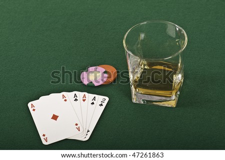 Four aces, chips and a drink