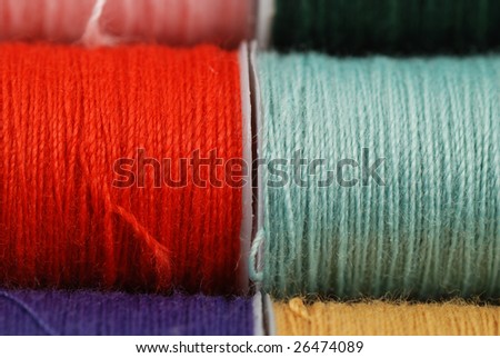 colorful spools of multi colored threads for sewing and knitting