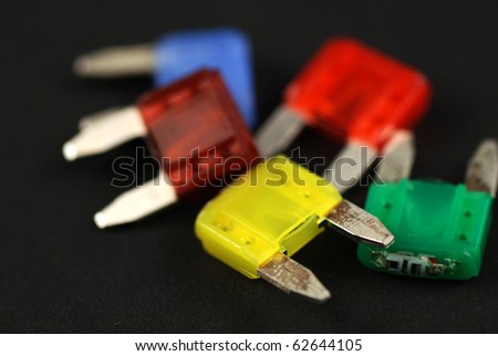 electrical automobile fuses with shallow depth of field on black background