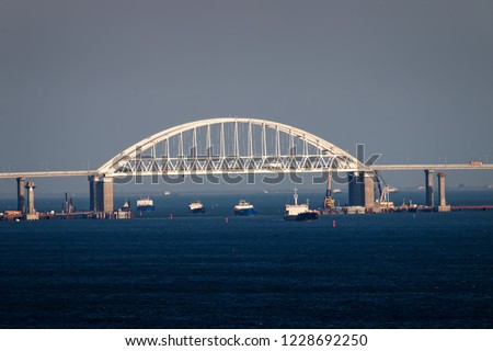Crimean bridge road across Kerch Strait with leading cargo ships. Sea gate to the  Azov sea