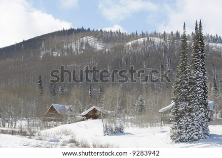 cabin in snow in mountains