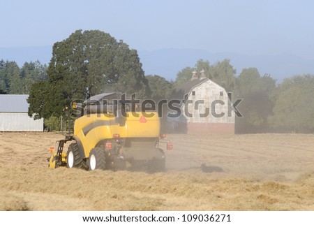 Combine working the field in spring wheat in the Willamette Valley in Oregon