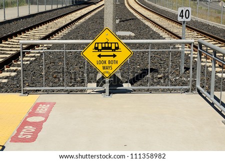 Warning signs and a subway train at a city mass transit station in Oregon