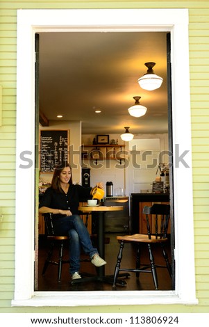 A young woman enjoys a fresh cup of tea at a tea house in a Northwest city