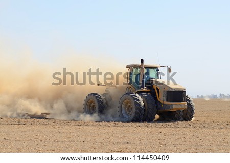 tractor pulling a disc soil finisher implement to smooth the soil after tillage and plowing
