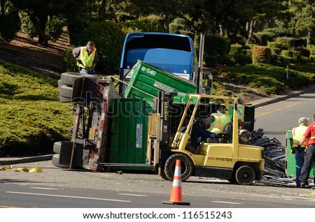 ROSEBURG, OR - OCTOBER 16:A truck loaded with scrap aluminum rolls on its side at the entrance to Interstate 5 causes backup in Roseburg Oregon, October 16, 2012