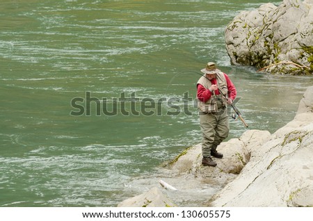 GLIDE OR - MARCH 2: A fisherman catching a spring chinook salmon on the popular North Umpqua River just above Glide OR at a place called Rock Creek, March 2, 2013