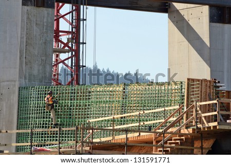Iron worker during the early construction of the new Portland Milwaukie light rail bride over the Willamette River