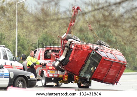 Roseburg, Or - March 19: A Tow Truck Lifts A Car Following A Rollover Accident During A Spring Rain In Roseburg Oregon, March 19, 2013