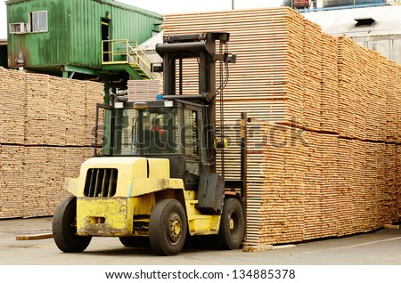 Large lift truck moving a stack of green fir 2 x 4 lumber studs at a small log processing mill in southern Oregon, ready for the drying kiln