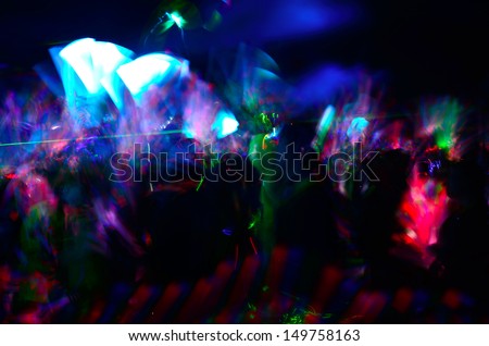 Color neon streaks of light glow sticks at a night celebration and rave