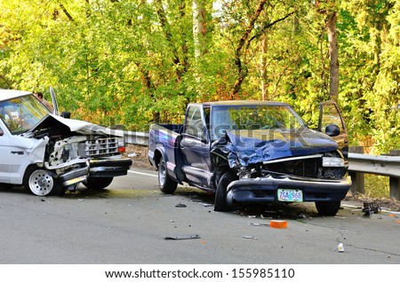 ROSEBURG, OR - AUGUST 29, 2013:Two vehicle head-on accident, caused by one truck failure to yield,  results in no injuries at a rural intersection in Roseburg, OR on August 29, 2013