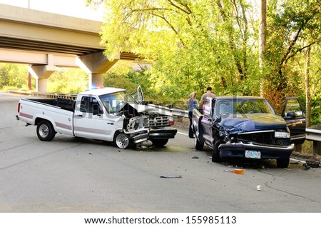 ROSEBURG, OR - AUGUST 29, 2013:Two vehicle head-on accident, caused by one truck failure to yield,  results in no injuries at a rural intersection in Roseburg, OR on August 29, 2013