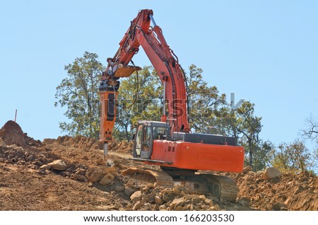 Construction bulldozer pushing out a new lift of dirt and rock for a new road on a commercial development project