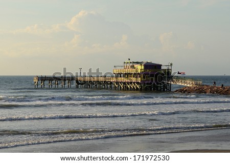 Sunrise in Galveston Texas and a restaurant pier in the Gulf of Mexico
