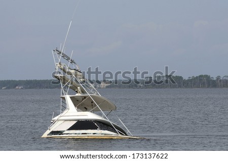 A large cabin cruiser fishing boat sits halfway underwater in sunk in Saint Andrew Bay - a result of a storm near Panama City in Florida.
