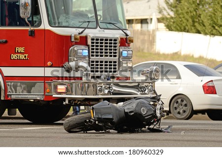 Emergency responders at the scene of a motorcycle vs car at a busy intersection that left the rider with serious injuries.
