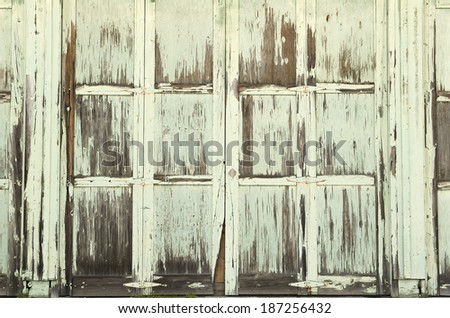 A large wooden industrial door shows it age