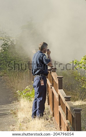 ROSEBURG, OR, USA - JUNE 10, 2014:  Firefighters respond to a single family home fire on a hot summer day in Roseburg, OR, USA on June 10, 2014