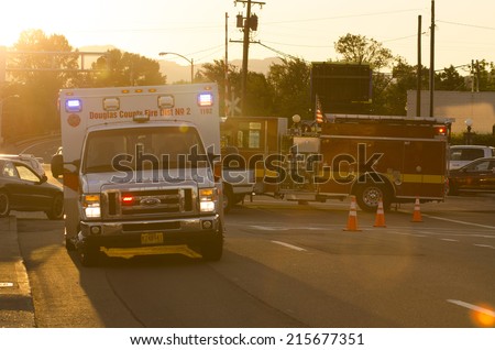 ROSEBURG OR, USA - JULY 12, 2014: Roseburg Oregon Police and Fire deparment at the scene of a single car accident that knocked over a fire hydrant, July 12, 2014