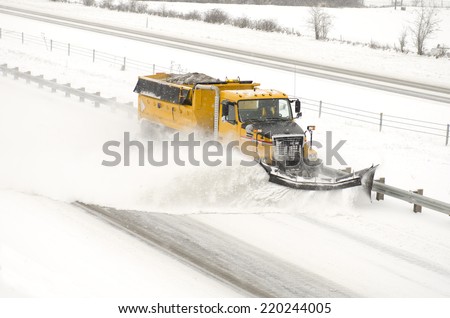 Snow plows clearing the freeway on Interstate 5 during a winter snow and freezing rain storm
