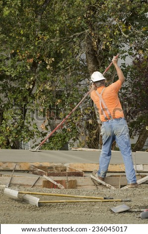 Concrete construction contractor installing a expansion joint in a sidewalk, curb and storm drainage gutter on a new urban road street project