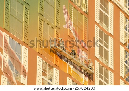 Las Vegas, NV, USA - November 11, 2014: Workers applying a billboard ad wrap of a new show on the outside of the Mirage hotel and Casino in Las Vegas