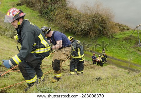 Roseburg, OR, USA - December 5, 2014: Douglas County Fire District #2 conducting a low angle rope rescue of a car crash victim