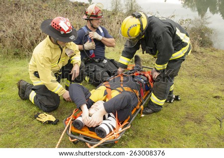 Roseburg, OR, USA - December 5, 2014: Douglas County Fire District #2 conducting a low angle rope rescue of a car crash victim