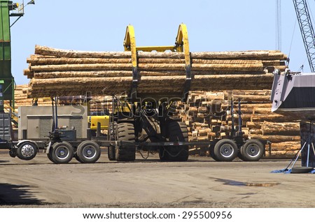 Fir logs being moved for loading onto a commercial ship for export to Asia on the mill dock in Astoria Oregon